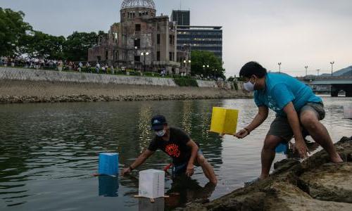 People floating paper lanterns on the Tenma River in Hiroshima, Japan.